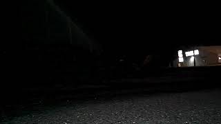 Fpv video of a remote control car driving around the parking lot of an apartment complex at night