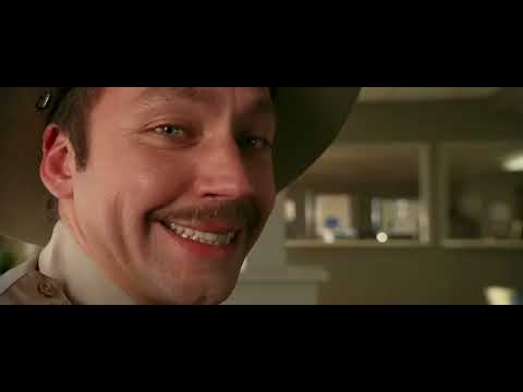 Trailer frame: dust and daylight as the General Lee crests a dirt road to guitar riffs