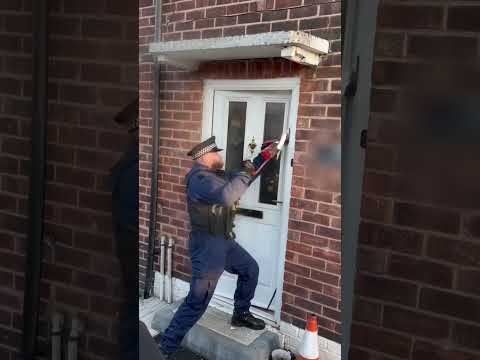Police struggle with door in Bury raid