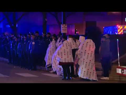 The bodies of two Chicago police officers who were fatally struck by a train were brought to the Cook County Medical Examiner's Office through a police procession early Tuesday morning. (Dec. 18)
