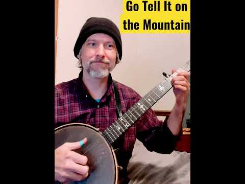 guy in red plaid shirt playing banjo