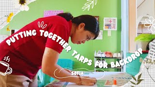 Deaf vlog: Putting together tarps for the backdrop on Thursday.