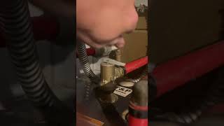 Slipping a drip pan under a hot water heater