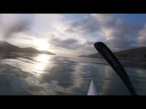 Chasing tug boat wash on a surf ski in a glass off