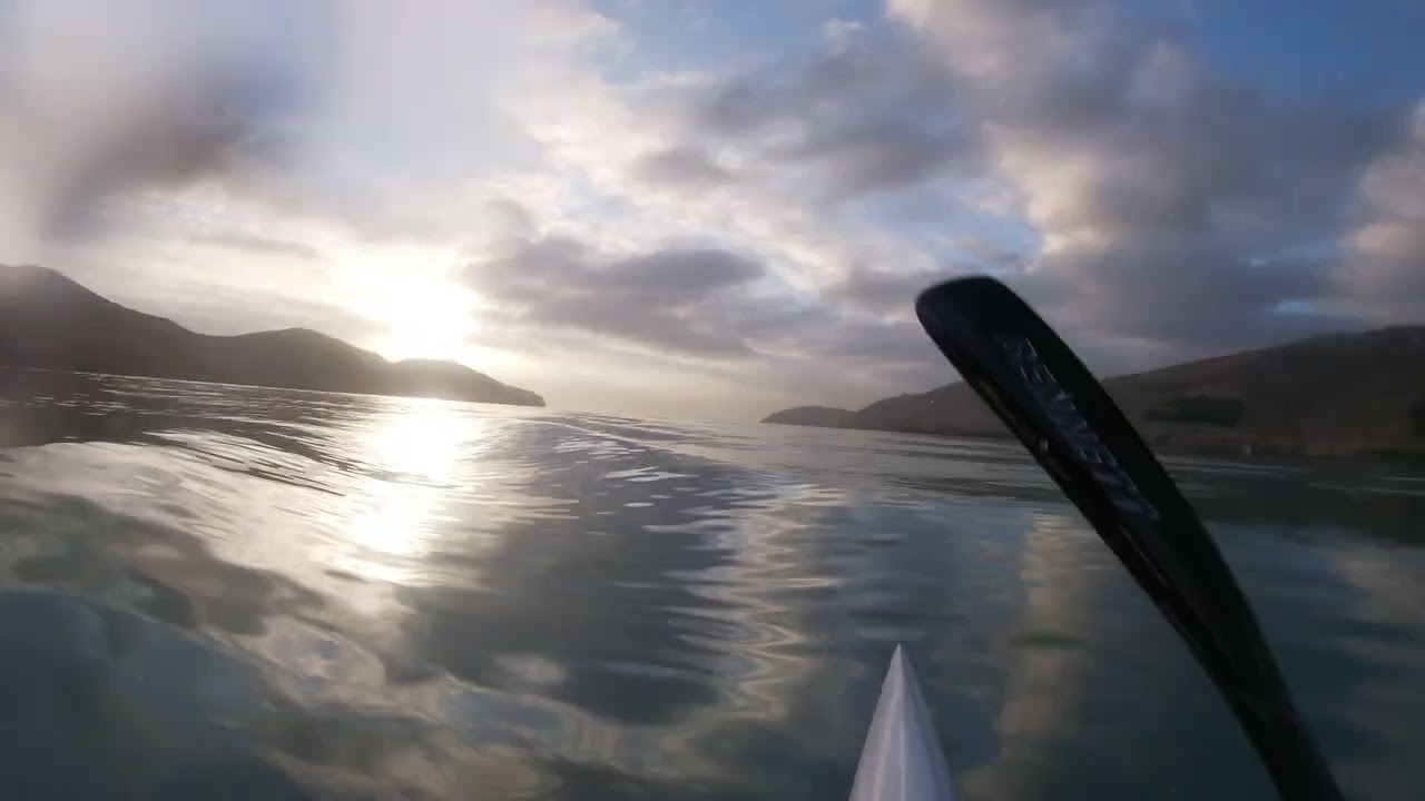 Chasing tug boat wash on a surf ski in a glass off