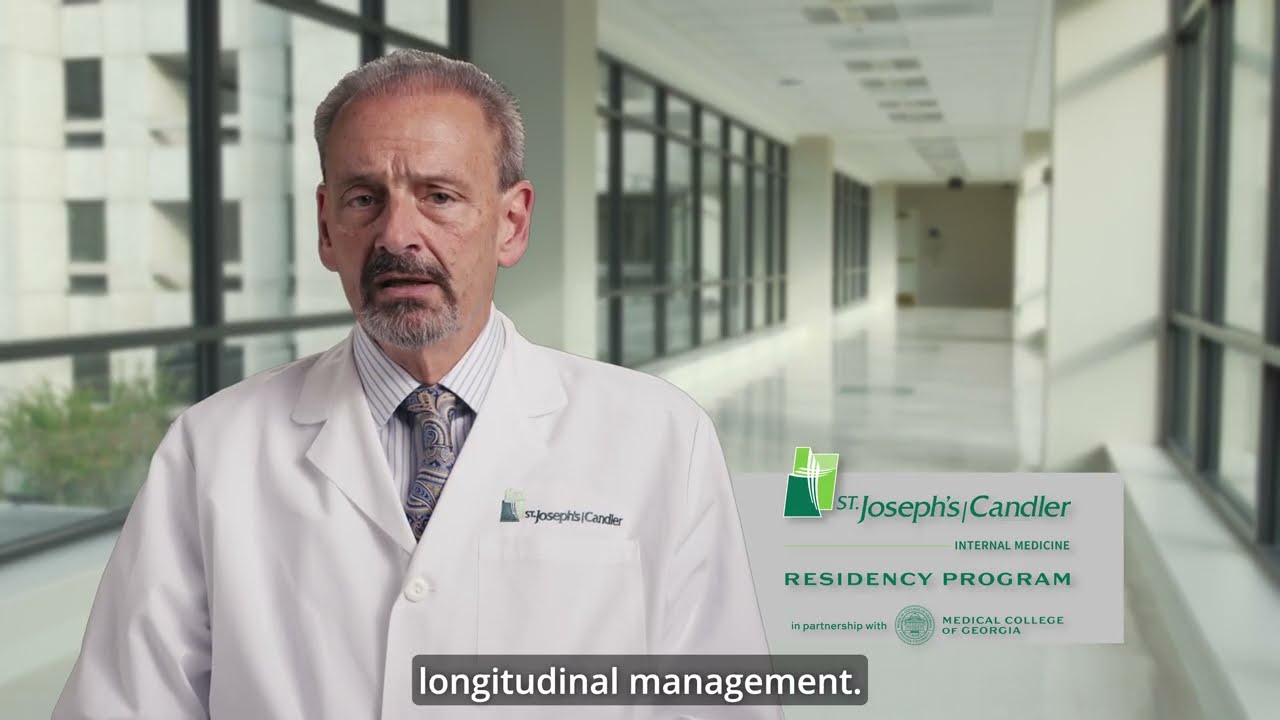 Residency Program director stands in hallway