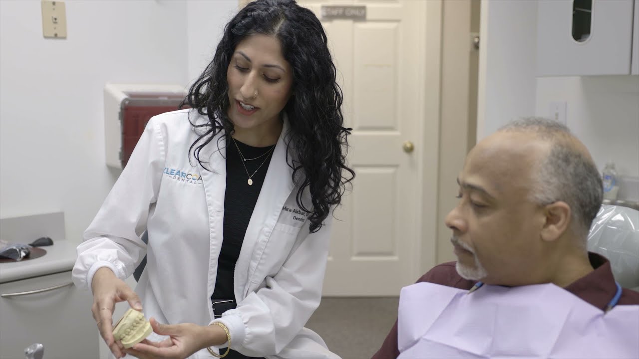 Dentist in New Bedford showing a patient a model of the teeth