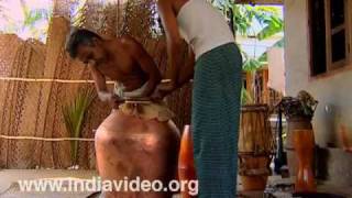 Making mizhavu, a pot shaped drum