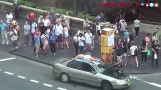 Man tans on car roof in the middle of main street in Sydney CBD!