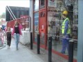 Mannequin Man dressed in PPE safety clothing standing in the window of the Machine Mart store in Docklands at the London Marathon 2011, acting like a mechanical moving mannequin, making a few Marathon spectators jump with a scare as they walked by. Mannequin Man dressed in PPE safety clothing standing in the window of the Machine Mart store in Docklands at the London Marathon 2011, acting like a mechanical moving mannequin, making a few Marathon spectators jump with a scare as they walked by.
