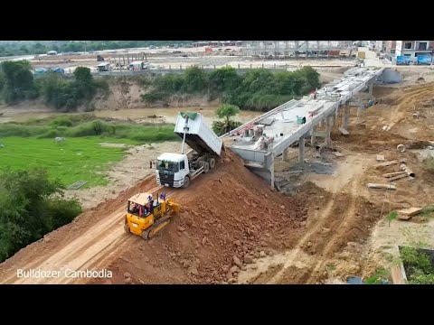 This world is truly amazing experts working to fill the ground to connect the bridge and make roads.