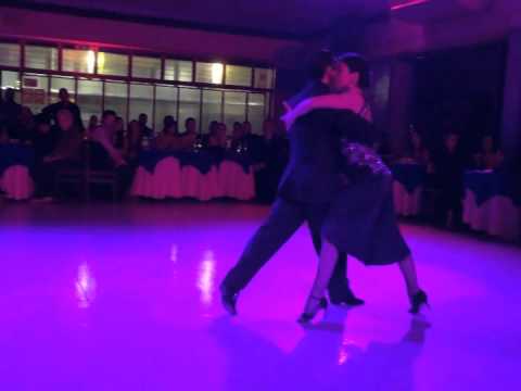  Noelia Coletti  and  Pablo Martin Giorgini  are  dancing  to  the  tango  "  Por Que Regresas Tu  "  by  Carlos di Sarli