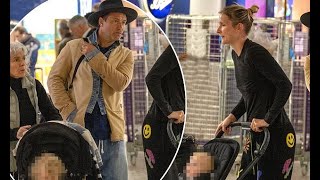 Jude Law, 50, is pictured with his new baby for the first time - after becoming a proud dad of SEVEN