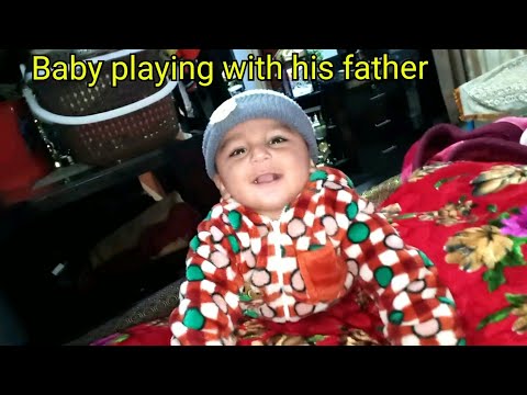 The child laughing while playing with his father|funny baby playing with daddy playing with father
