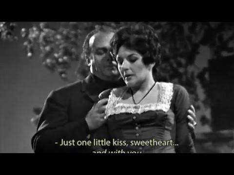 Ο βαρύτονος Tito Gobbi [Τίτο Γκόμπι] στον ρόλο του Μικέλε στο Il tabarro [Η κάπα] του Giacomo Puccini [Τζάκομο Πουτσίνι], από την τηλεοπτική σειρά Great Characters in Opera του BBC (1966). Μονόπρακτη όπερα βασισμένη στο έργο La houppelande [Η χλαίνη] του Didier Gold [Ντιντιέ Γκολντ], συγκαταλέγεται στα δείγματα του βερισμού, με τη ρεαλιστική απόδοση της ζήλιας, της φτώχειας και του εγκλήματος στον κόσμο των εργατών του Σηκουάνα.