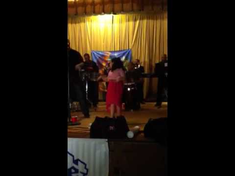 Sasha Cevallos dancing on stage with Jose Adeliz y su orque