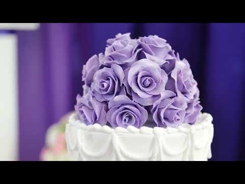 "Elegant White Wedding Cake with Purple Floral Accents | Stunning Bridal Cake Design"