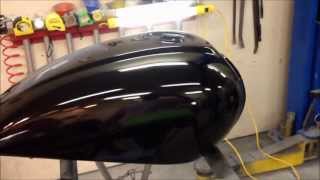 Finishing a paint job on motorcycle a gas tank at the UGG, sanding and detail work
