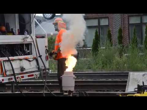 Thermite Welding a Rail and a Westbound Intermodal Train