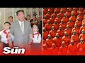 North Korean Troops March In Bizarre Red Hazmat Suits As Kim Jong Un Celebrates Midnight Parade