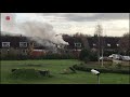 Vlammen slaan uit dakkapel bij woningbrand