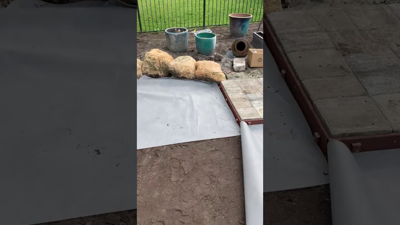 Installing Weed Fabric Between Soil and Stone Base for Artificial Turf