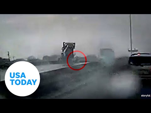 Trucker tumbles to safety as big rig rolls off highway overpass USA TODAY