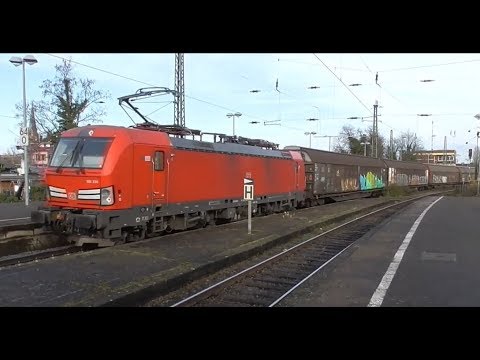 Heavy freight train on its way through the train station