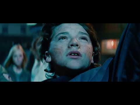 Super 8 trailer frame — flashlights scan a freight yard after the wreck