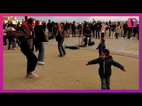 Onlookers In Park Copy Girl's Moves When She Dances To Street Musician