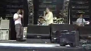 Mark Donnelson singing on stage with 311