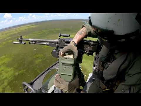 U.S. Marines firing M240D machine gun and a GAU-21 .50-caliber machine gun