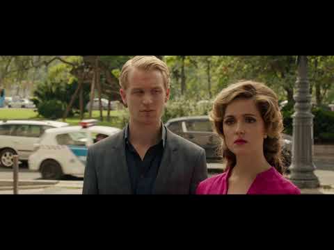 Spy trailer frame — club lights and covert looks in the Budapest sequence