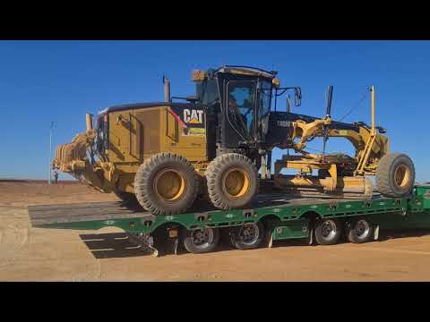 140m Cat Grader loaded onto tilt tray for service