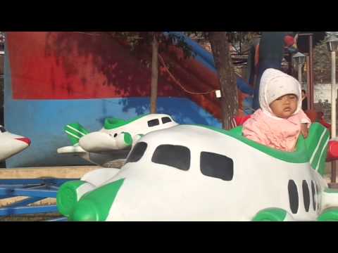 aarvee on toy plane at fun park