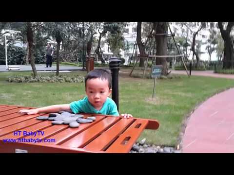 Baby playing with a small stone in the garden, count the small stone with fun Video