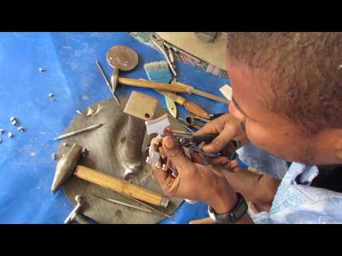 Tuareg silver smith making a cross in Agadez, Niger