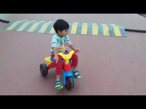 Baby riding tricycle.