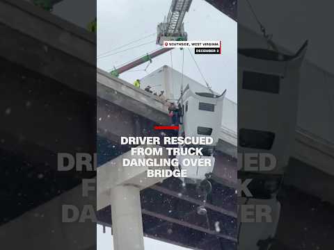 Driver rescued from tractor-trailer dangling over bridge