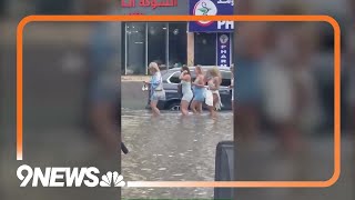 UAE: People wade through floodwaters in Dubai