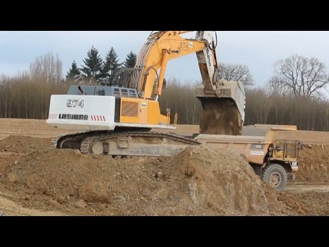 Liebherr 974 Excavator Loading CAT Dump Trucks