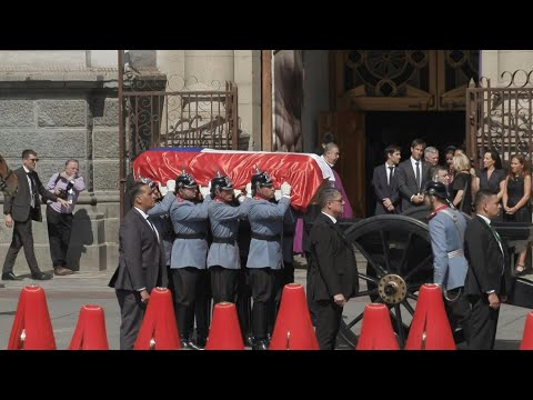 Coffin transporting body of Sebastian Pinera arrives at cathedral | AFP