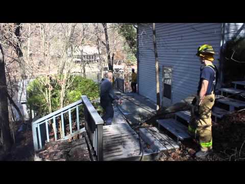 Firefighters cut a tree burning on the inside at Lake of the Ozarks