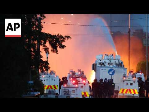 Police blast water cannons at Belfast protesters as unrest flares again after stabbing