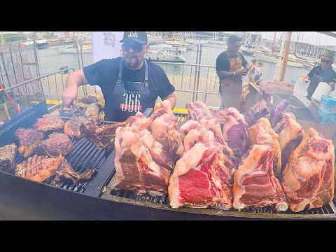 Barcelona Street Food. Invasion of Giant Florentine Steaks on Grill. Meat&Fire