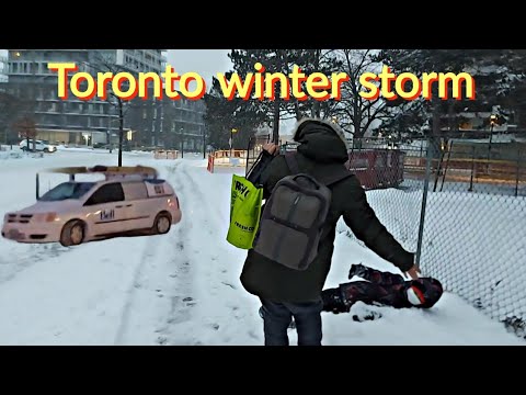 TORONTO CANADA WALK ON SIDEWALK IN A NEIGHBORHOOD DURING A WINTER STORM