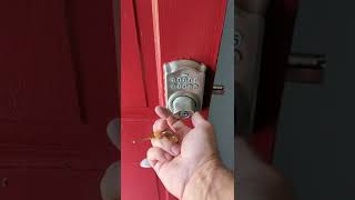 Operating the override key with a Schlage BE365 push button deadbolt.