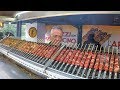 Huge Automatic Machines Grilling Lots of Lamb Skewers. Italy Street Food