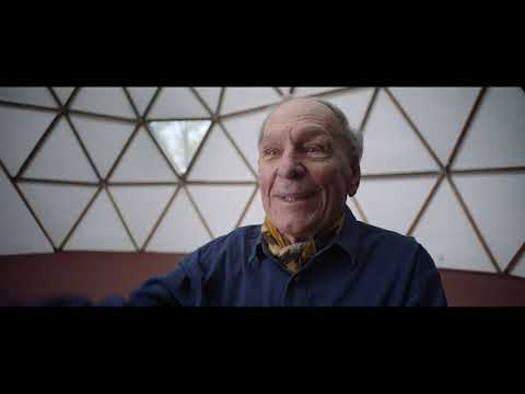 Spaceship Earth official trailer frame: the glass pyramid of Biosphere 2 glinting in Arizona sun
