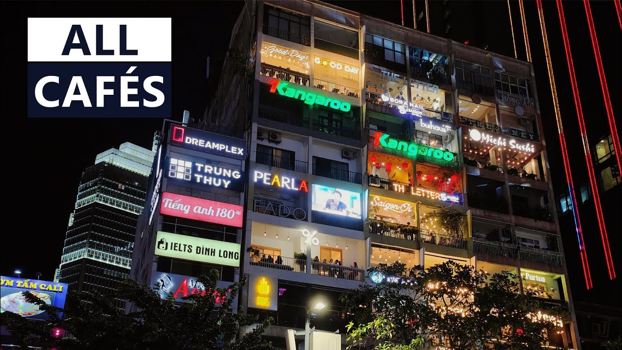 Experience the captivating allure of Cafe Apartments, a beacon of Ho Chi Minh City nightlife, with its radiant facade and bustling cafes.